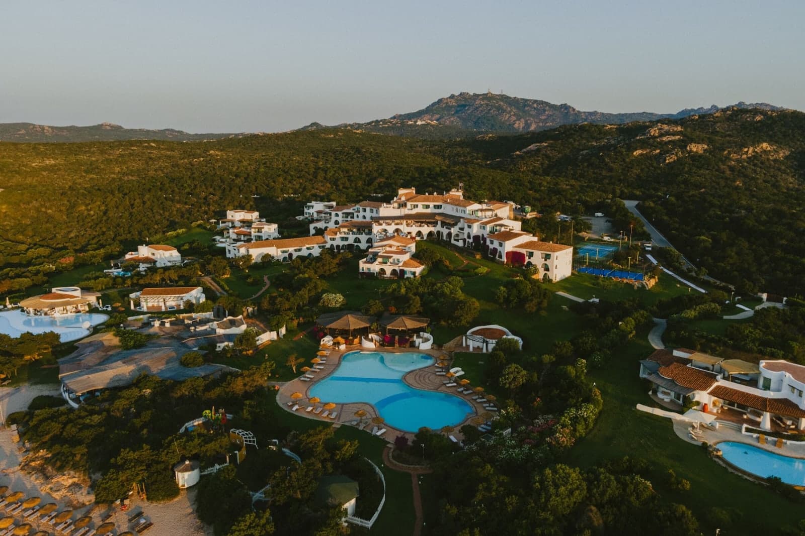 Aerial view of the Romazzino hotel and its pools above the Costa Smeralda coast