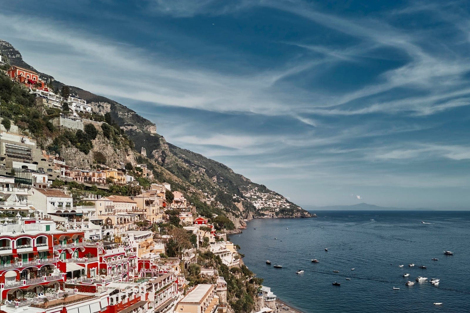 Pastel cliffside buildings above the beach at Positano on the Amalfi Coast