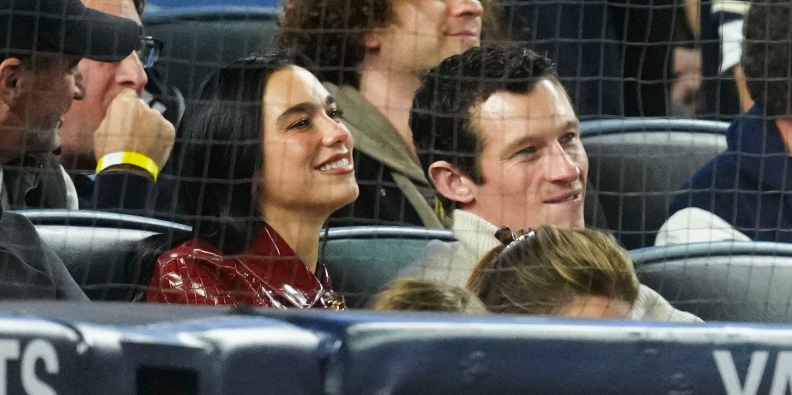 Dua Lipa wearing a Chanel coat at a Yankees game