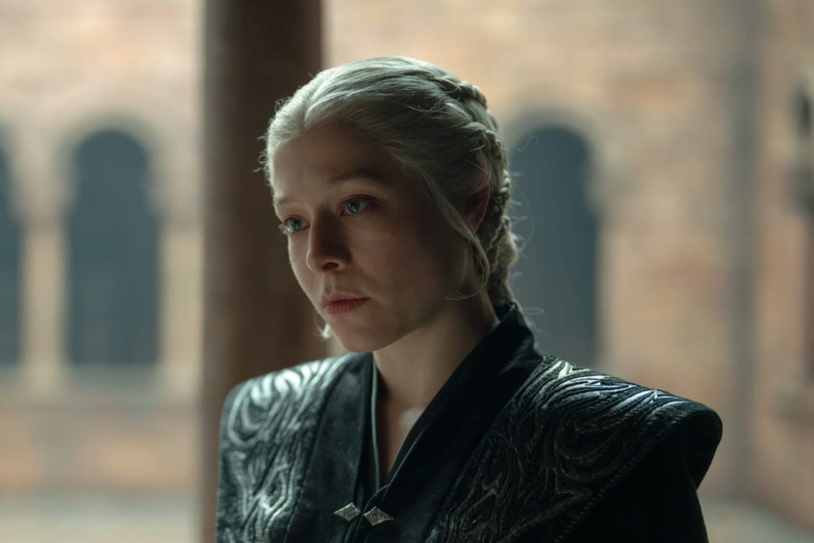 Two characters in conversation in a candlelit hall in House of the Dragon season three