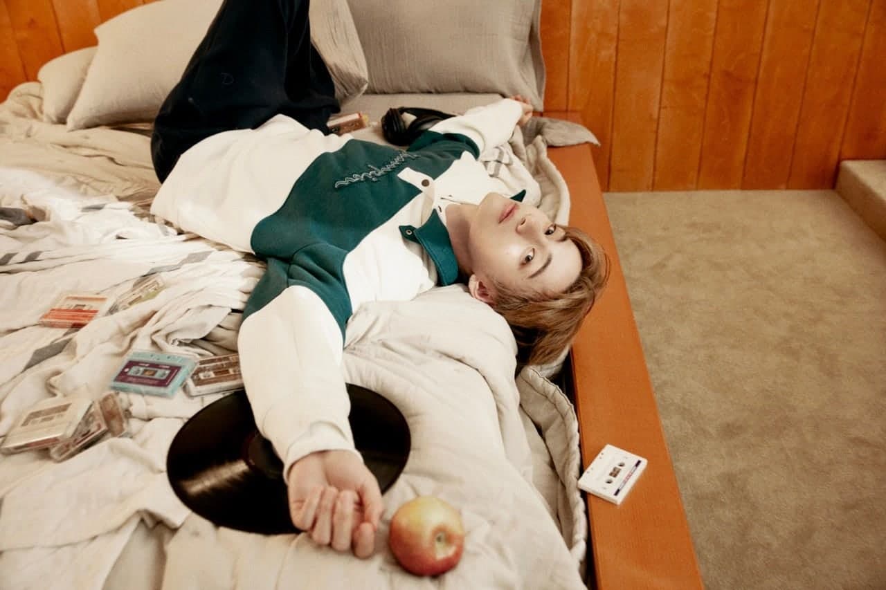 Kim Taehyung photographed for the Champion True Champion campaign surrounded by cassette tapes and records