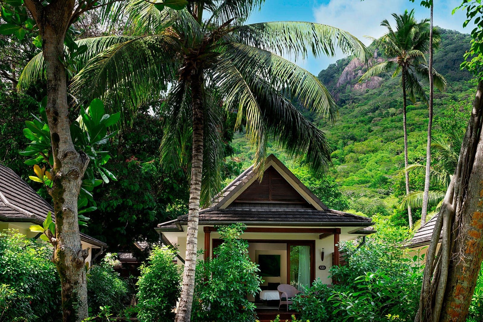 A tropical villa surrounded by palms and dense green planting in the Seychelles