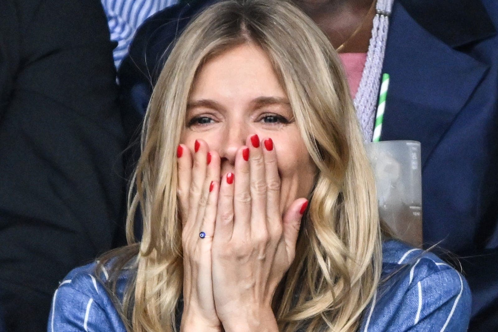 A close view of a tomato red manicure