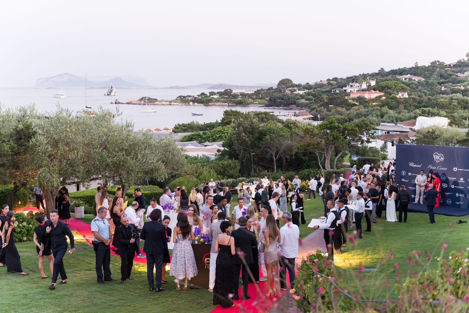 Guests arriving on the lawns at Romazzino above the Costa Smeralda at sunset