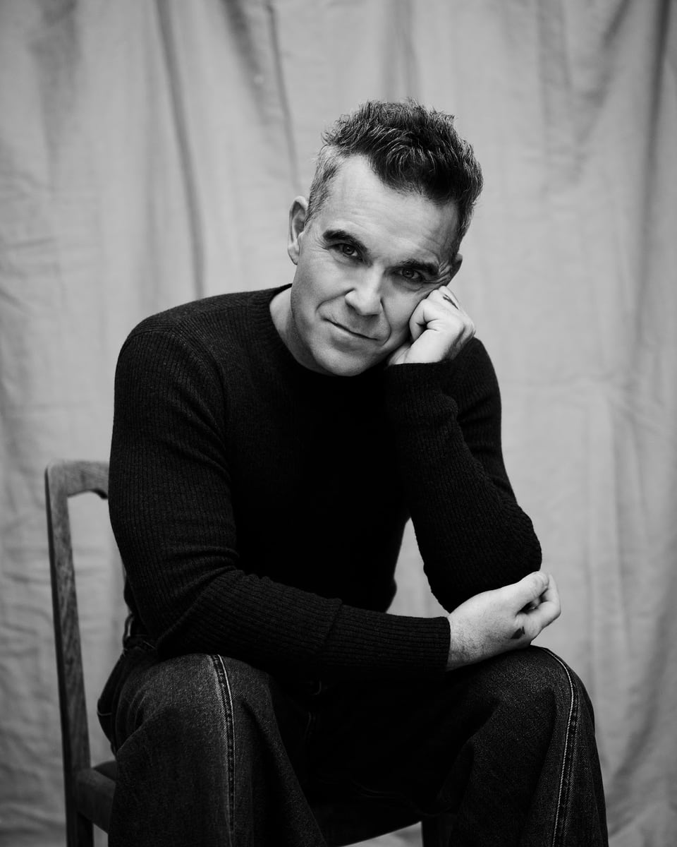 Robbie Williams photographed in a black and white portrait